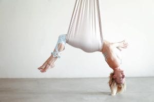 beautiful photo of founder of aireal yoga doing backbend in aerial hammock