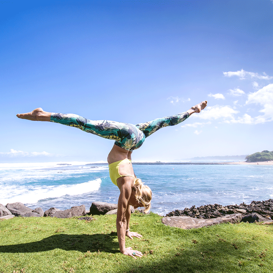 Carmen Curtis, the founder of AIReal Yoga, doing a handstand at Wanderlust Festival Hawaii.